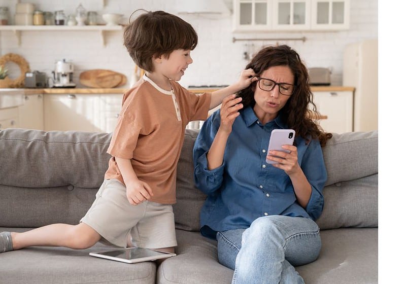 mother on phone while child wants her attention